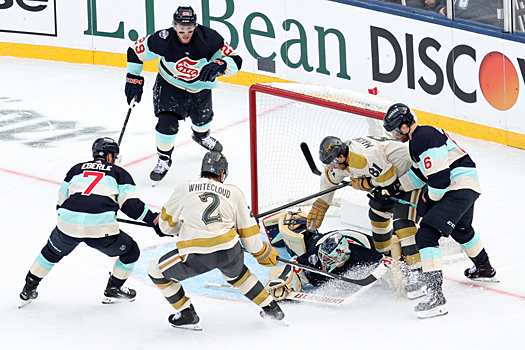 Kraken goalie Joey Daccord covers the puck as Golden Knights Zach Whitecloud (2) and Jonathan Marchessault (81) look for a rebound as Jordan Eberle (7) and Adam Larsson (6) provide support