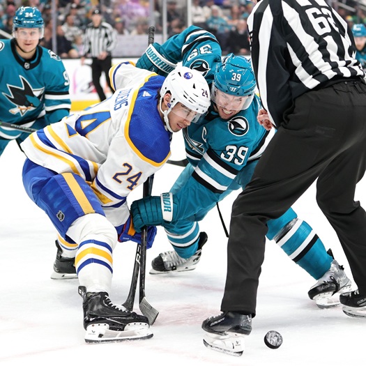 Sabres Dylan Cozens (24) and Sharks Logan Couture face-off during first period action