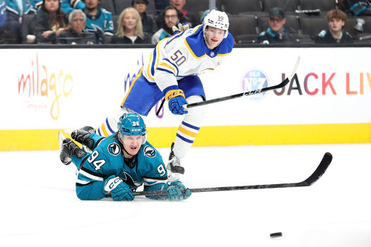Sharks forward Alexander Barabanov (94) dives to make a pass in front of Eric Robinson (50)