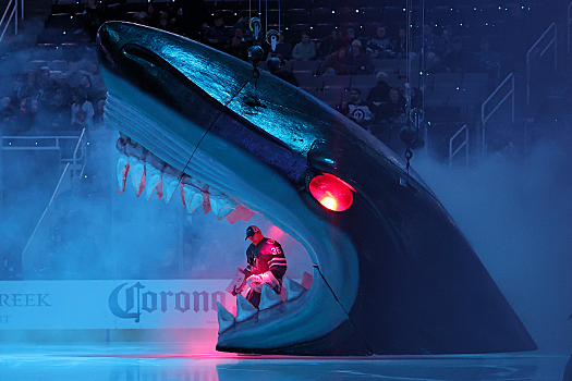 Sharks goalie Kappo Kahkonen skates through the Sharks head during pregame introductions