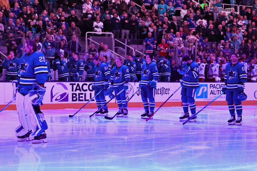 Sharks players stand for the national anthem