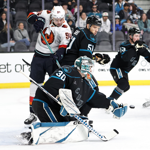 Barracuda goalie Magnus Chrona stops a shot as defenseman Radim Simek attempts to check Devin Shore (94) looking for a rebound
