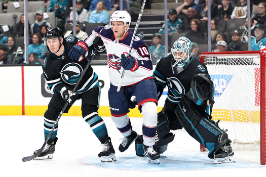 Blue Jackets forward Dmitri Voronkov (10) battles for position in front of Sharks goalie Kaapo Kahkonen and defenseman Ty Emberson (6)