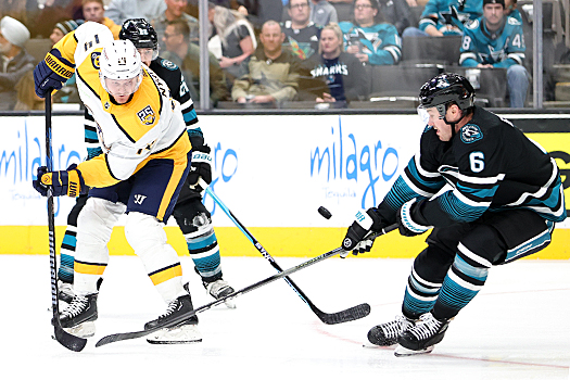 Predators forward Gustav Nyquist (14) takes a back handed shot on goal in front of Sharks defenseman Ty Emberson (6)