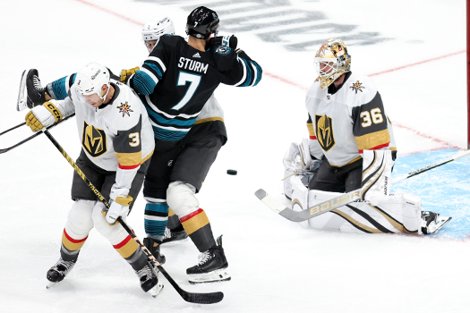 Sharks center Nico Sturm (7) is checked by Vegas defenseman Brayden Pietrangelo (3) as goalie Logan Thompson blocks the shot