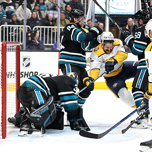 Sharks defenseman Jan Rutta (84) checks Filip Forsberg (9) as goalie Kaapo Kahkonen covers the puck