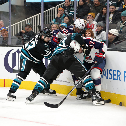 Sharks defenseman Nikita Okhotiuk (center) holds Justin Danforth (17) as Calen Addison (33 ) and Alexandre Texier (42) move in the fight for the puck