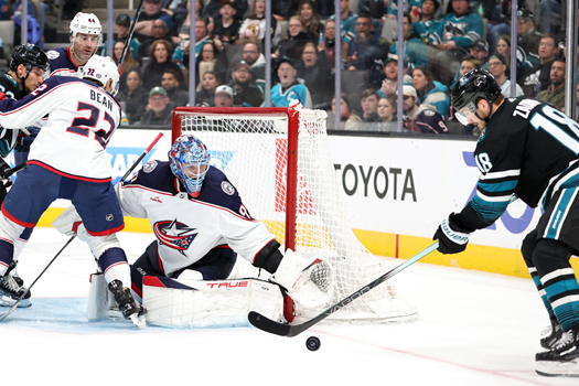 Sharks forward Filip Zadina (18) shoots the puck on net as goalie Elvis Merzlikins reaches to stop the shot