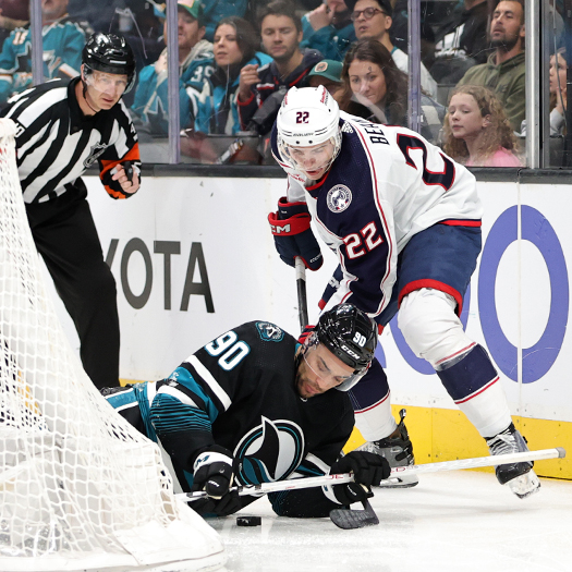 Sharks forward Justin Bailey (90) attempts to move the puck away from Blue Jackets defenseman Jake Bean (22)