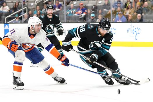 Islander Kyle Palmieri (21) and Sharks Mario Ferraro (38) battle for puck possession