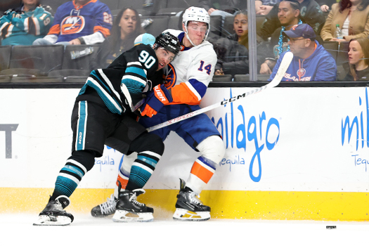 Justin Bailey (90) checks Bo Horvat (14) off the puck