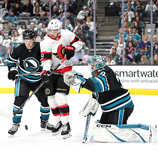 Senators forward Drake Batherson (19) attempts to tip the puck past goalie Magnus Chrona as Henry Thrun (3) defends