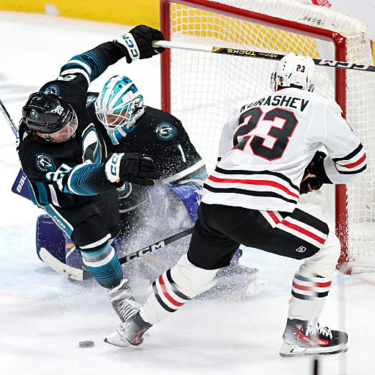 Sharks forward Fabian Zetterlund (20) collides with goalie Devin Cooley as Philipp Kurashev (23) looks for the loose puck
