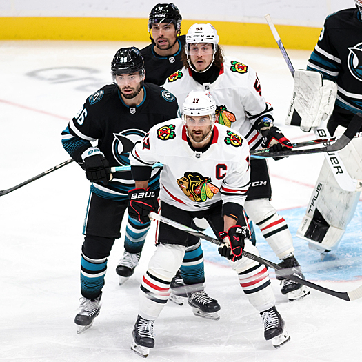 Blackhawks Nick Foligno (17) and Tyler Bertuzzi (59) look for a pass as Sharks Jake Walman (96) and Cody Ceci (4) defend